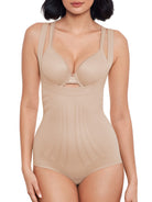 a woman wearing a beige open-bust shaping bodysuit