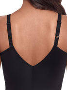 a close-up detail of a woman wearing a black shaping bodysuit romper