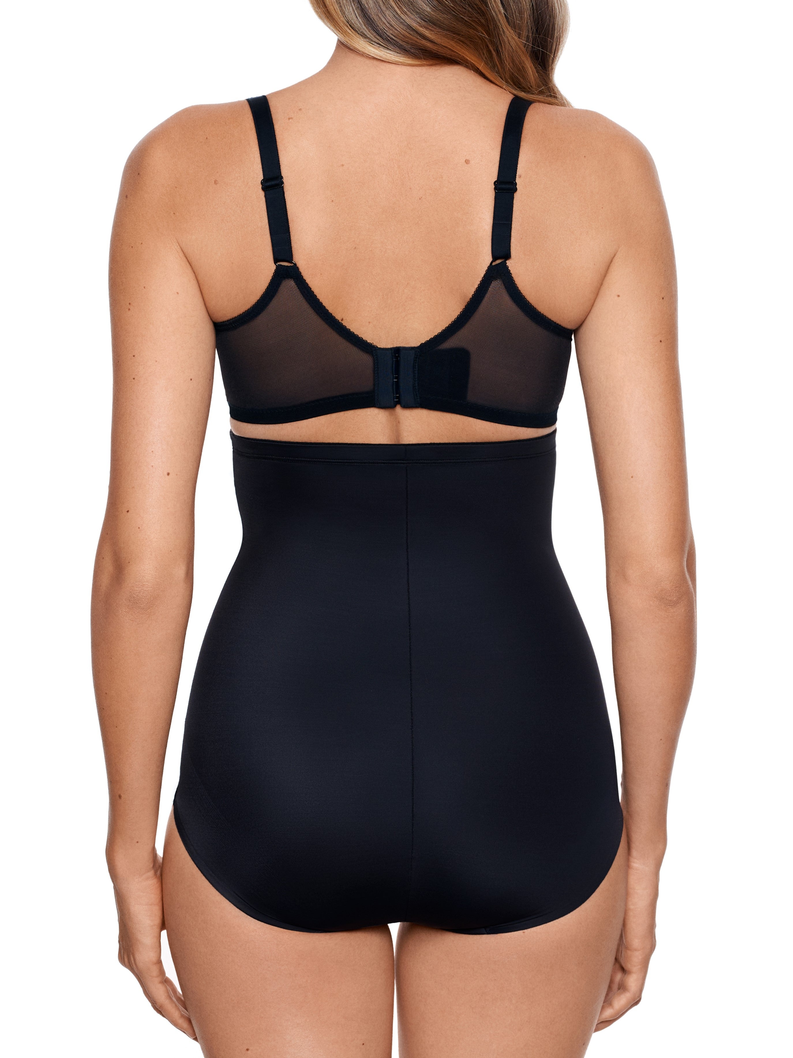 a woman wearing black high waisted tummy control underwear shapewear