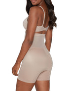 a woman wearing nude high waisted tummy control shapewear shorts