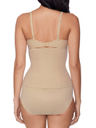 a woman wearing a beige waist cincher