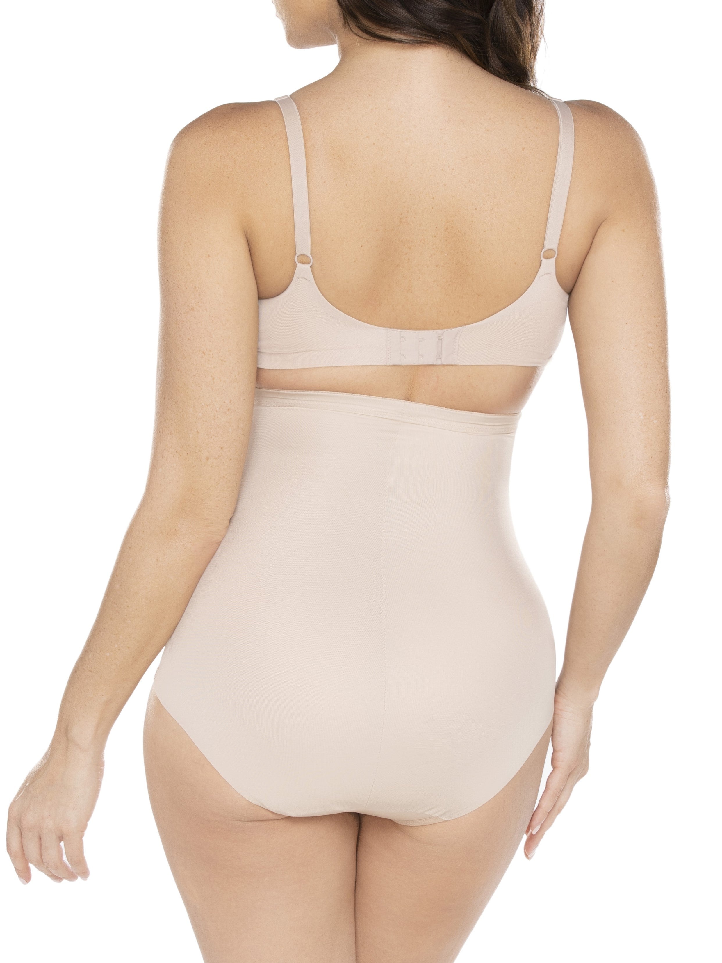 a woman wearing a beige shaping brief