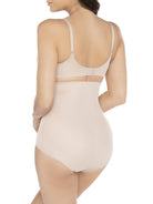 a woman wearing a beige shaping brief