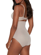 a woman wearing a beige shaping brief