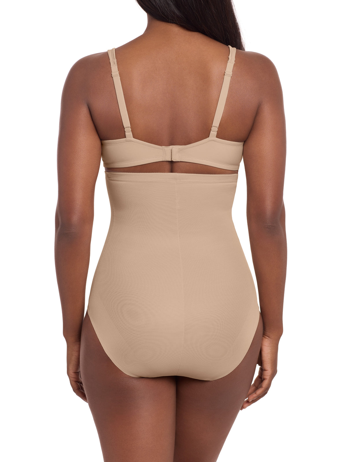 a woman wearing a beige high waisted tummy control brief miraclesuit shapewear body shaper
