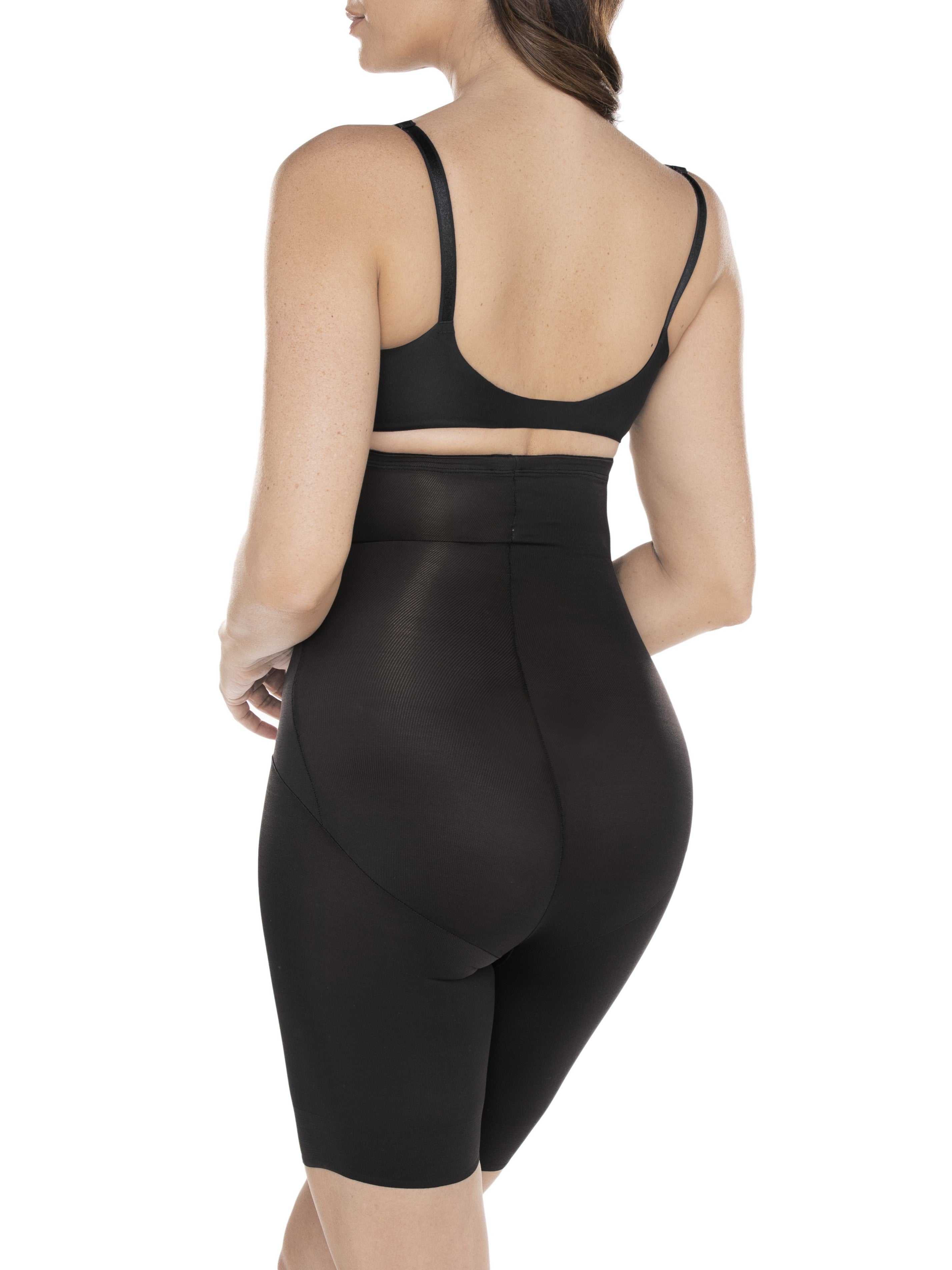 a woman wearing black high waisted tummy control shapewear shorts