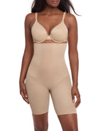 a woman wearing a beige high waisted tummy control thigh slimmer shaping short miraclesuit shapewear