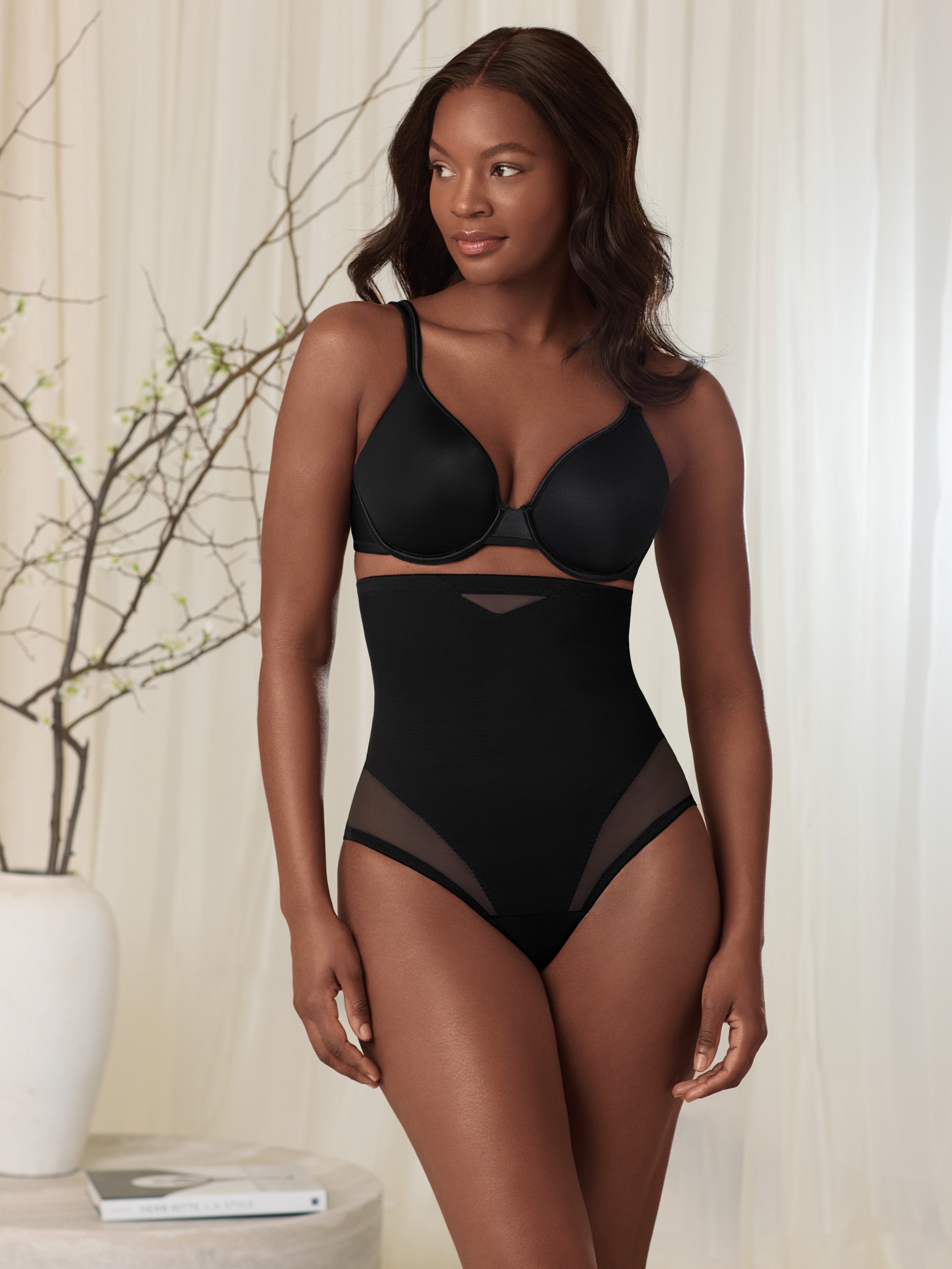 a woman wearing a black sheer high waisted tummy control top thong panty shapewear all-groups