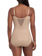 a woman wearing a beige tummy control shaping bodysuit miraclesuit shapewear body shaper sheer shapewear