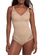 a woman wearing a beige tummy control shaping bodysuit miraclesuit shapewear body shaper sheer shapewear