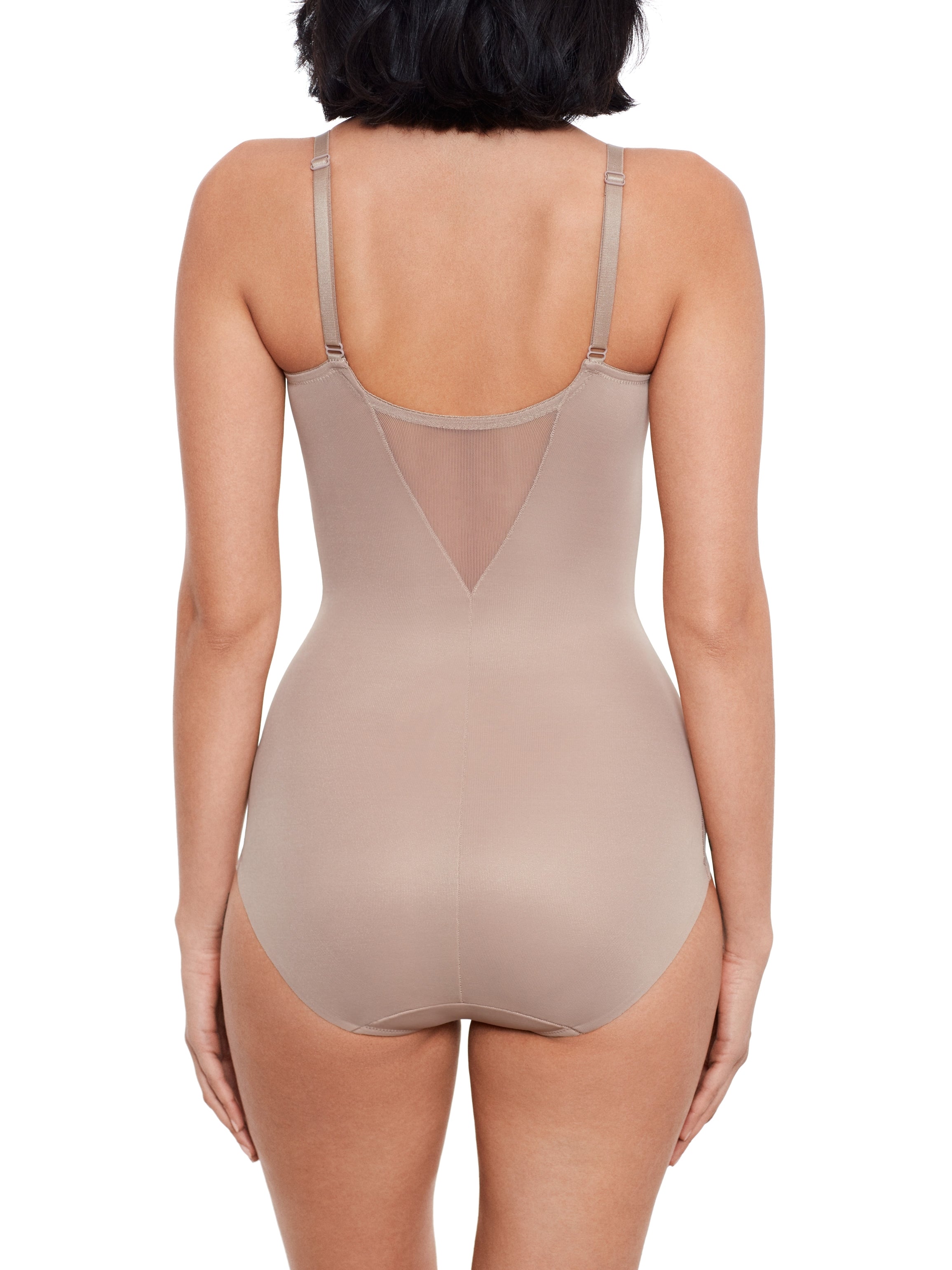 a woman wearing a beige shaping bodysuit