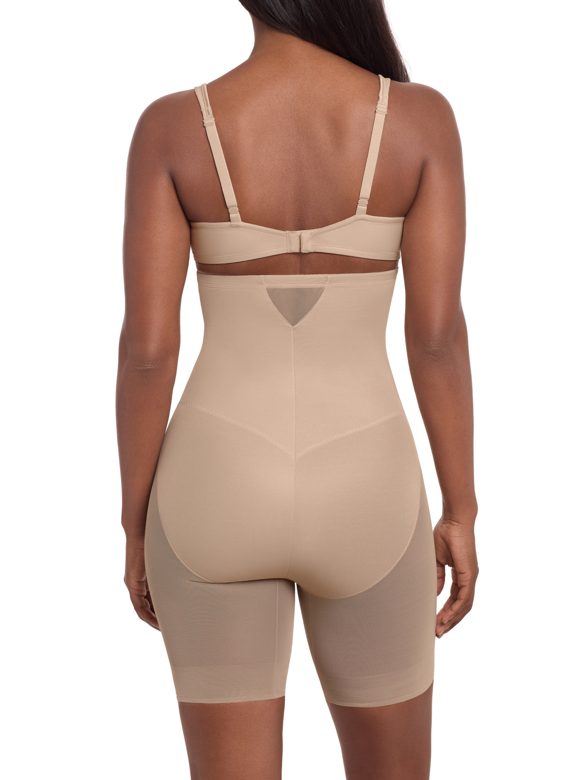 a woman wearing a beige sheer shapewear high waisted tummy control short thigh slimmer miraclesuit shapewear