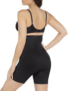 a woman wearing a black high waisted tummy control shapewear short