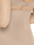 a close up of a woman wearing a nude high waisted tummy control shapewear short