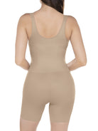 a woman wearing a nude open-bust tummy control bodysuit