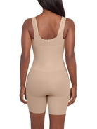 a woman wearing a beige open bust tummy control shaping bodysuit full body shaper miraclesuit shapewear torsette