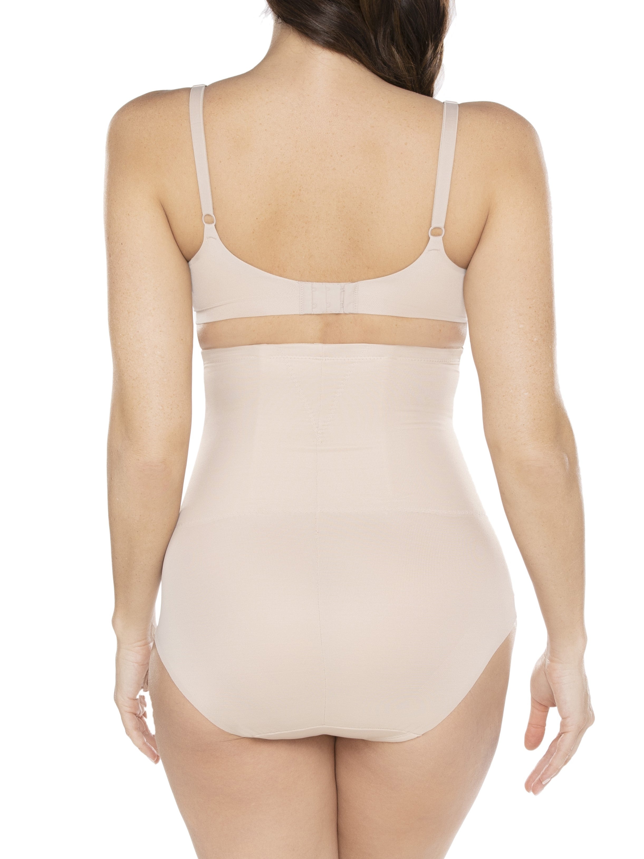 a woman wearing a beige shaping brief