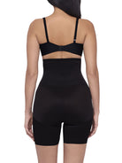 a woman wearing a black high waisted tummy control shaping short back smoothing body shapewear miraclesuit shapewear
