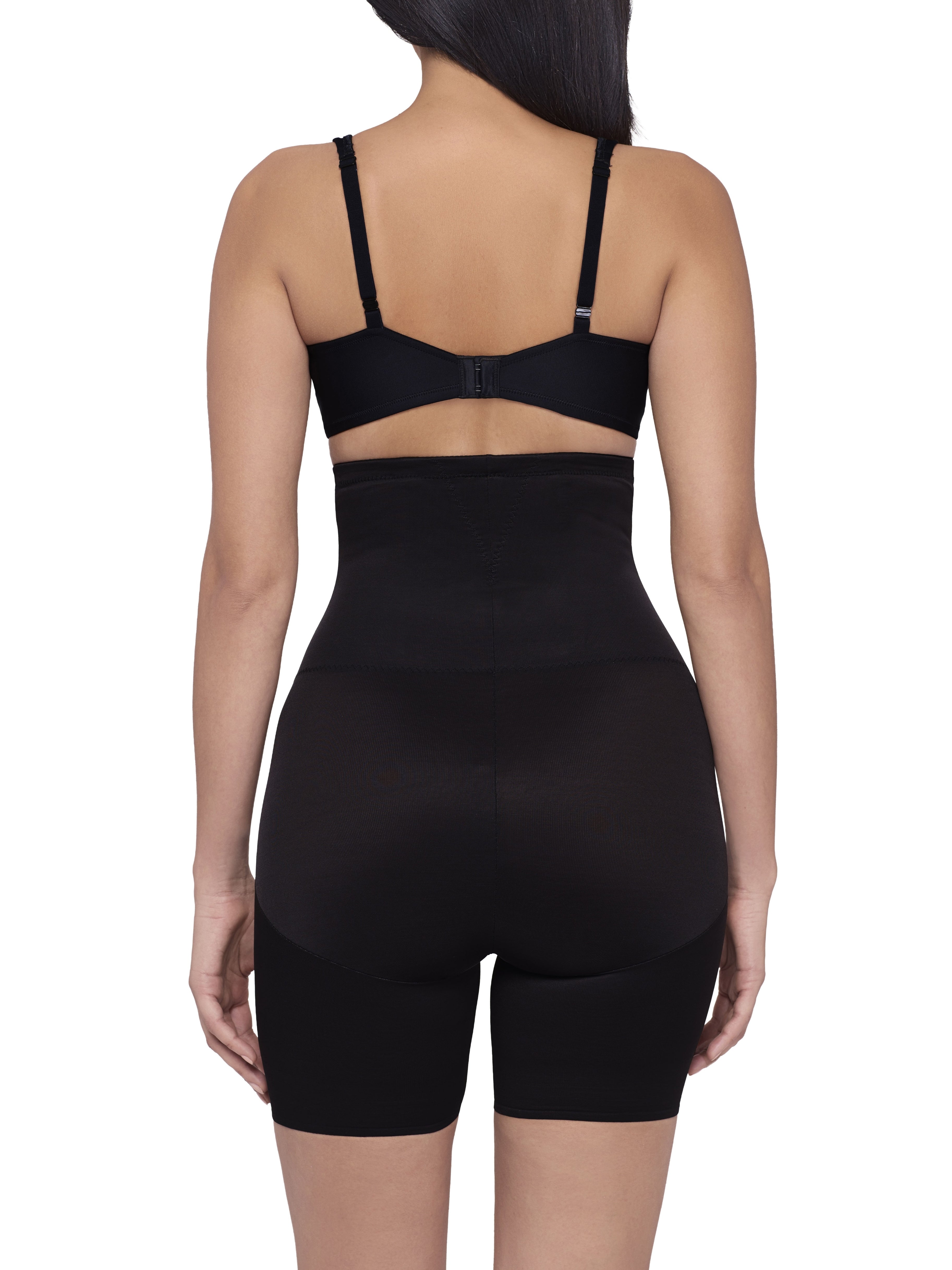 a woman wearing a black high waisted tummy control shaping short back smoothing body shapewear miraclesuit shapewear