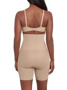 a woman wearing a beige high waisted tummy control shaping short thigh slimmer miraclesuit shapewear