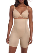 a woman wearing a beige high waisted tummy control shaping short thigh slimmer miraclesuit shapewear