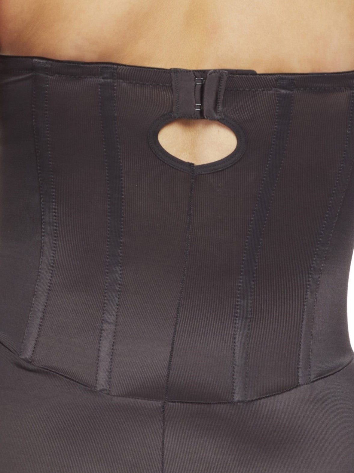 a close-up detail of a woman wearing a black strapless tummy control body shaper shapewear