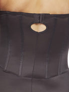 a close-up detail of a woman wearing a black strapless tummy control body shaper shapewear