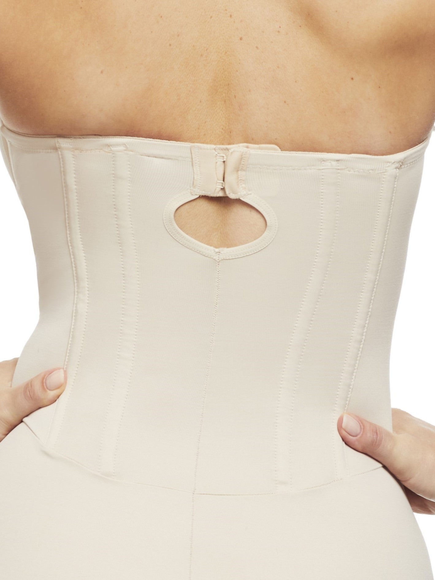 a close-up detail of a woman wearing a nude strapless tummy control body shaper shapewear