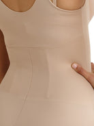 a close-up detail of a woman wearing a nude open bust body shaper