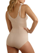 a woman wearing a beige open-bust shaping bodysuit