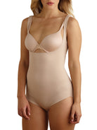 a woman wearing a beige open-bust shaping bodysuit