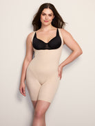 a woman wearing a nude open bust tummy control body shaper all-groups