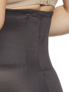 a close-up detail of a woman wearing a black shaping short
