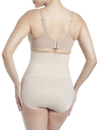 a woman wearing a beige shaping brief