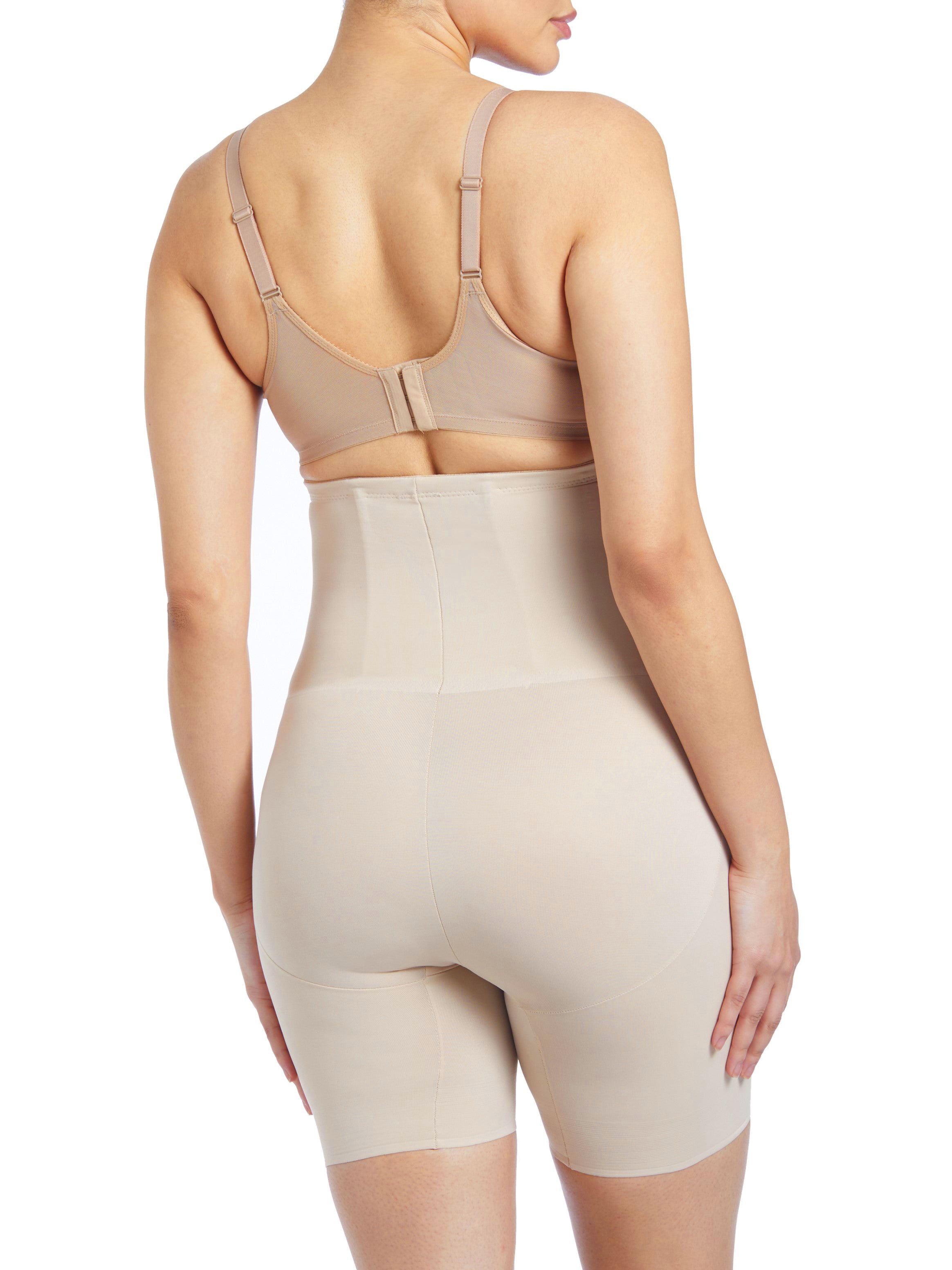 a woman wearing nude high waisted tummy control shapewear shorts