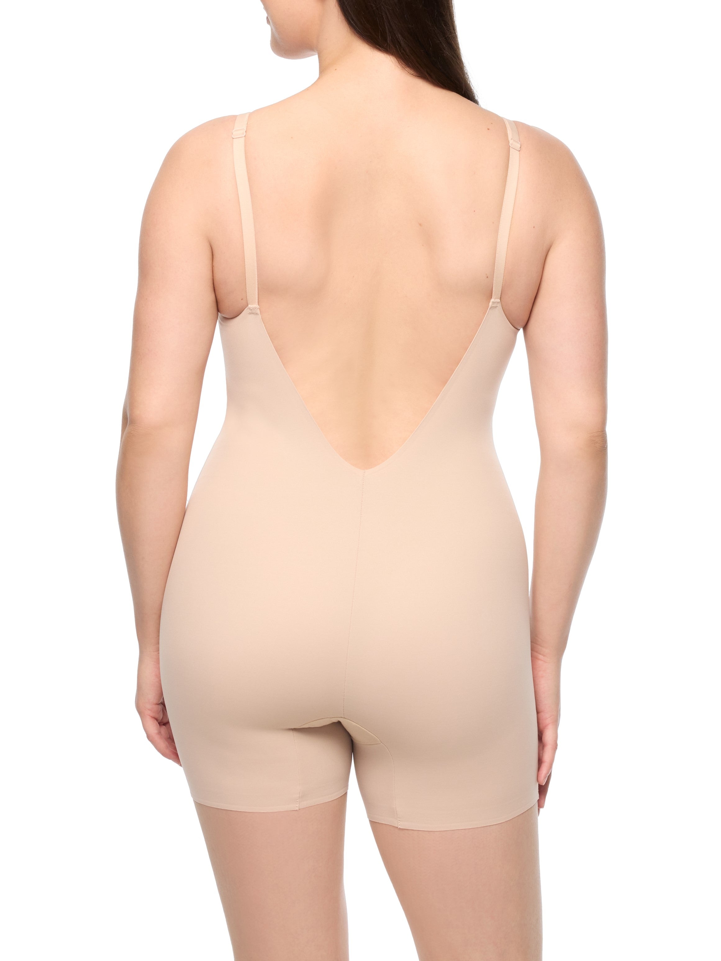 a woman wearing a nude low back shapewear bodysuit