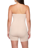Beige strapless bodysuit worn by a model on a white background