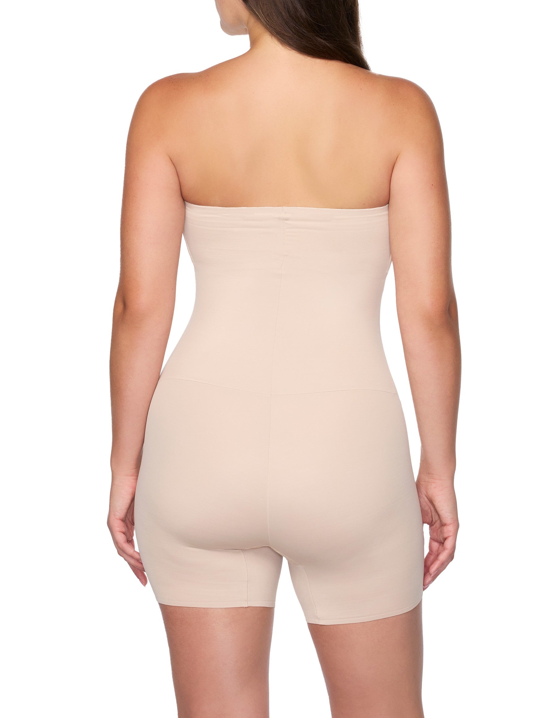 Beige strapless bodysuit worn by a model on a white background