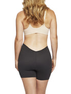 a woman wearing a black low back shapewear shorts