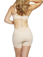 a woman wearing a nude low back shapewear shorts