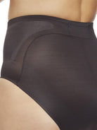 a closeup detail of a woman wearing black tummy control underwear