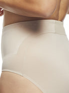 a closeup detail of a woman wearing nude tummy control underwear shapewear