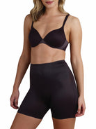 a woman wearing a black tummy control shapewear short