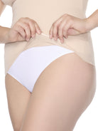 a close up of a silicone hem on a woman wearing a nude shaping cami