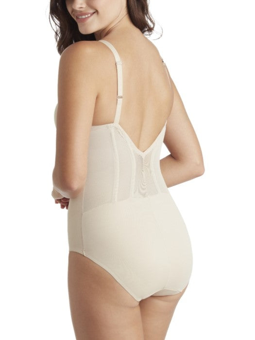 a woman wearing a nude tummy control body shaper shapewear bodysuit