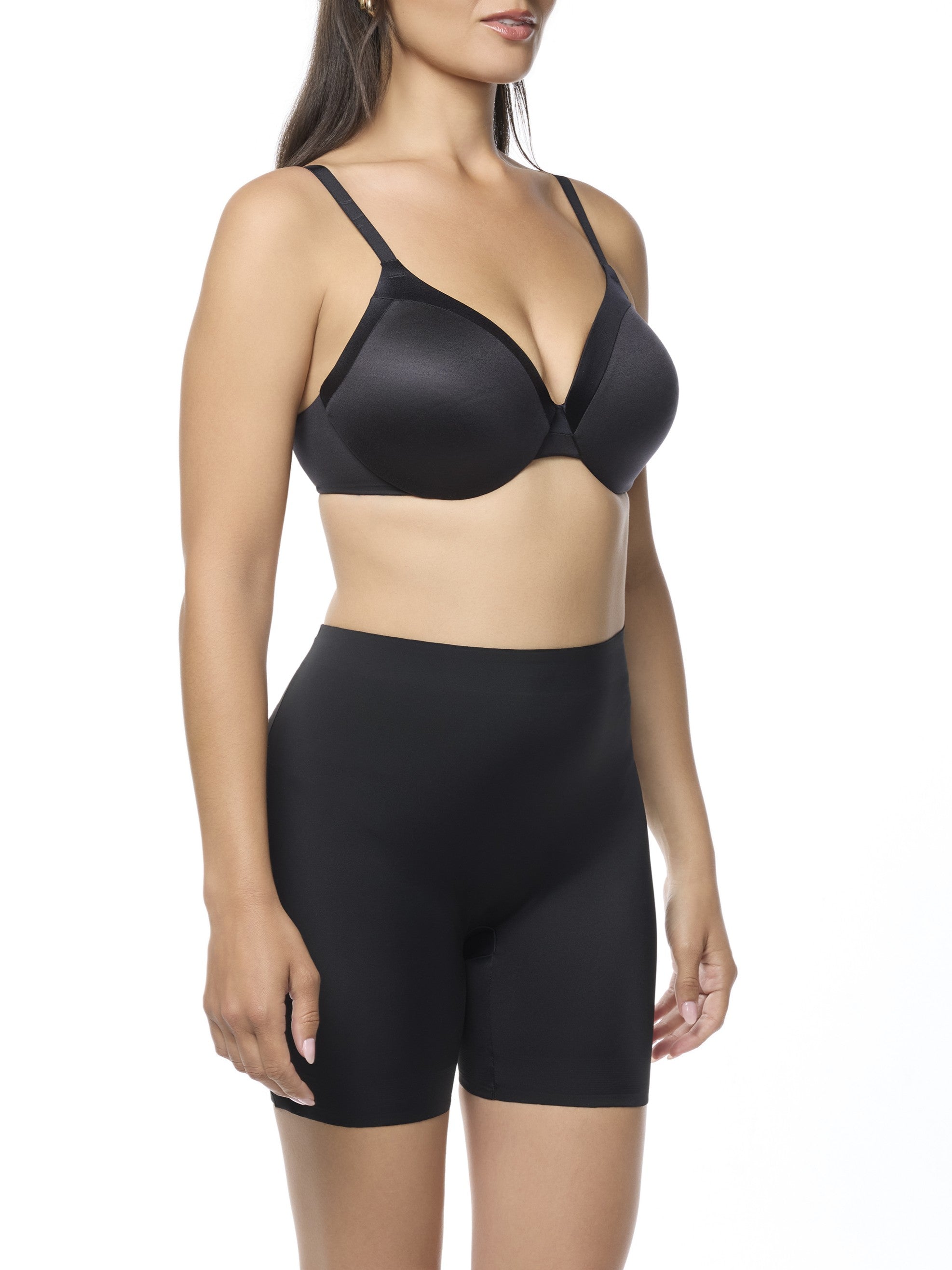 Woman wearing a black bra and shaping short on a white background