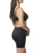 Woman wearing a black bra and shaping short on a white background