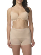 A woman wearing a sheer beige shaping boyshort with shaping panels