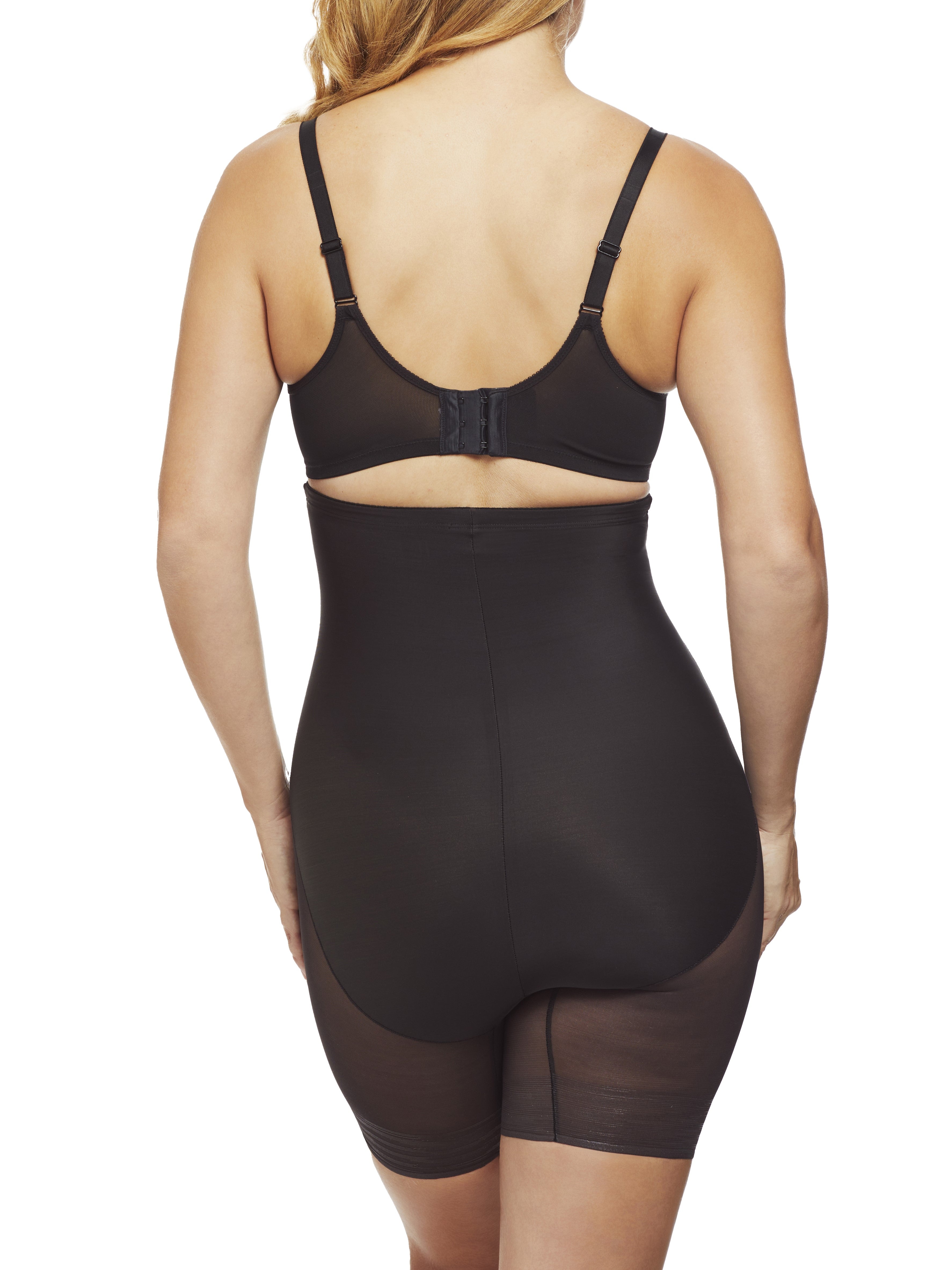 a woman wearing black high waisted tummy control shapewear shorts