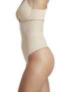 a woman wearing a beige shaping thong